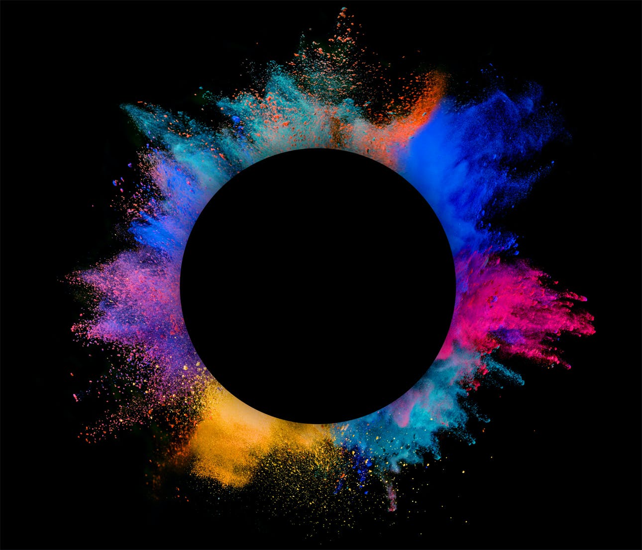 Explosion of colored powder on black background